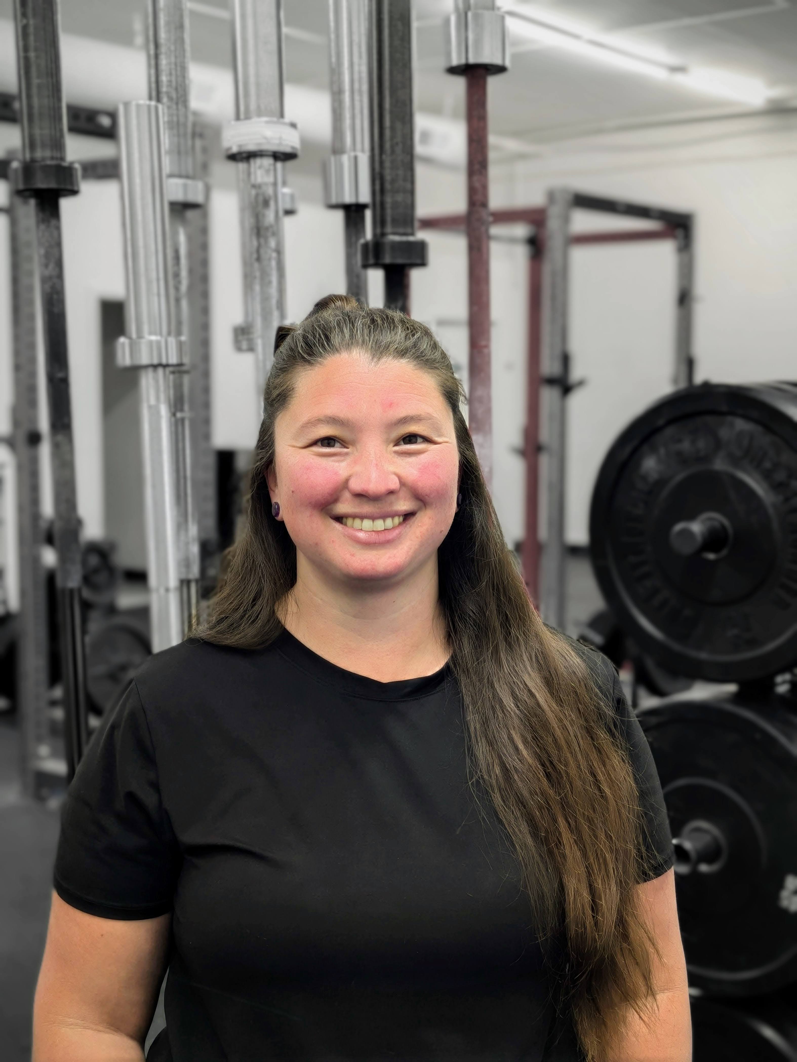 Dr. Nicole Sharp, PT, DPT — founder of Sharp Physical Therapy and Performance, standing in a gym setting